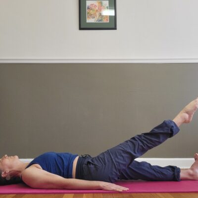 Pilates supine leg series lift mid movement